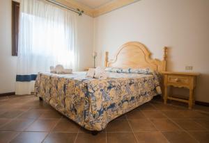 A bed or beds in a room at Il Giardino degli Oleandri