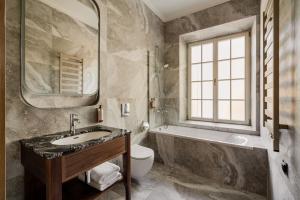 a bathroom with a sink and a toilet and a window at Zinar Castle in Krakow +126 photos