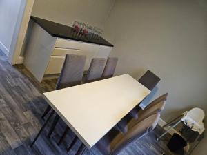 a white table and chairs in a room at Cunninghame 3 in Beith