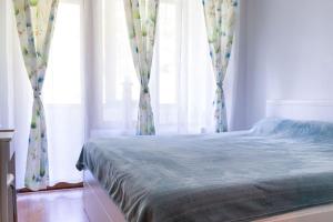 a bedroom with a bed and a window with curtains at Mountain Apartment in Borovets Ski Resort in Borovets