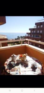 een tafel op een balkon met uitzicht op de oceaan bij Acapulco II, 1a LINEA, Playa Amplaries in Oropesa del Mar