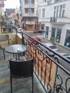 a balcony with a table and chairs and a street at MAHALI HOTEL in Batumi
