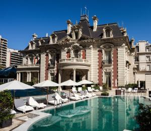a large building with a swimming pool in front of it at Four Seasons Hotel Buenos Aires in Buenos Aires