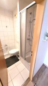 a bathroom with a shower and a toilet at Appartement Bahnhof in Mainz