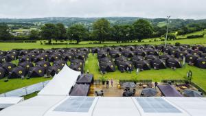 an event with black umbrellas in a field at Global-Tickets Village Spa-Francorchamps in Francorchamps