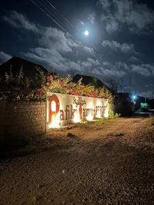 een muur met een bord waarop staat: bij Nadia&Ale House - Maisha Resort in Watamu