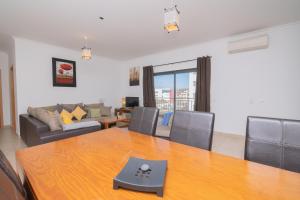 ein Wohnzimmer mit einem Tisch und einem Sofa in der Unterkunft Palmeiras de jv in Lagos