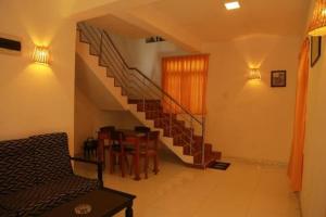 a living room with a staircase and a table and chairs at 31 sea view in Tangalle