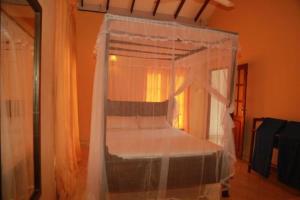 a bedroom with a bed with a canopy at 31 sea view in Tangalle
