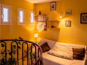 a living room with yellow walls and a couch at Live Roque Puertito Guimar in Puertito de Güímar +62 photos