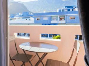 a table and two chairs on a balcony with a view at Live Roque Puertito Guimar in Puertito de Güímar