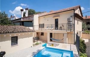 a villa with a swimming pool in front of a house at Villa Giorgio Jursici in Svetvinčenat