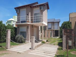 a house with a balcony on top of it at Faros de Sol in Monte Hermoso