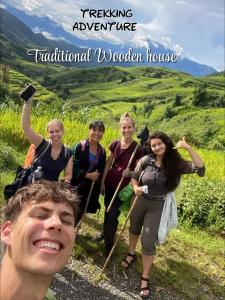 a group of people on a hiking adventure traditional wooden house at Traditional Wooden house & trekking adventure in Sa Pa