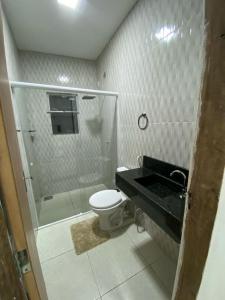 ein Bad mit einer Dusche, einem WC und einem Waschbecken in der Unterkunft Alemanha aconchego in São Luís