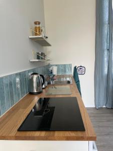 a kitchen with a wooden counter top with a sink at La possibilité d'une île in Boyardville +1 photo