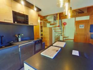 a kitchen with a counter top with a sink and a stove at Appartement Villard-sur-Doron, 5 pièces, 10 personnes - FR-1-594-226 in Villard-sur-Doron