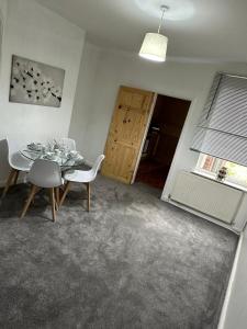 a dining room with a table and chairs and a window at Cosy Nest Getaways in Hickleton