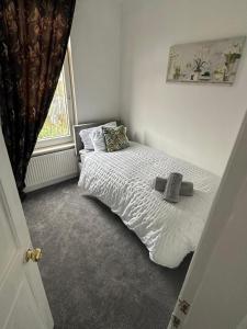 a small bedroom with a bed and a window at Cosy Nest Getaways in Hickleton