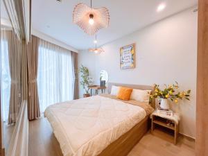 a bedroom with a bed and a large window at The Song Luxury Condotel Vung Tau - Xuân's Homestay in Vung Tau