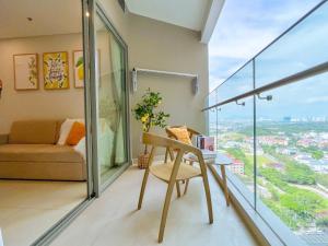 a living room with a table and a couch and a window at The Song Luxury Condotel Vung Tau - Xuân's Homestay in Vung Tau