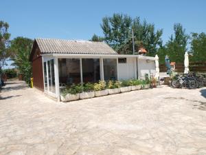 a building with a greenhouse with bikes parked outside at Apartments and bungalows vila Dalibor in Nin