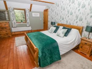 a bedroom with a large bed and a window at Hafan Dawel in Llanfyrnach