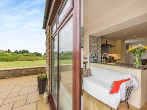 a view from the kitchen of a house with a large window at Beacon - Uk44719 in Ravenscar