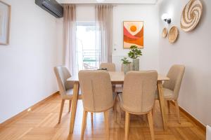 a dining room with a wooden table and chairs at AinCAC Apartment Athens Center in Athens