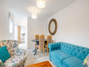 - un salon avec un canapé bleu et une table dans l'établissement Eleni Loulou - Uk43585, à Ellesmere