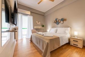 a bedroom with a large white bed and a window at AinCAC Apartment Athens Center in Athens