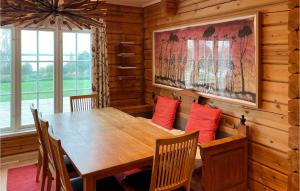 a dining room with a wooden table and chairs at Lovely Home In Mora With Sauna in Mora