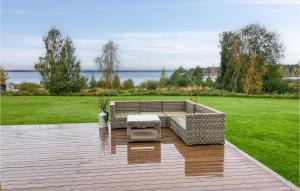 a patio with a couch and a table on a deck at Lovely Home In Mora With Sauna in Mora