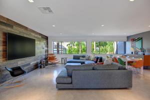 a living room with two couches and a flat screen tv at Ultra Luxury Resort Like Compound Pool, Spa, Fire Pit- Close to Everything- 4BD/2.5BTH in Palm Springs