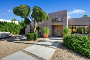 a house with a tree in the front yard at Ultra Luxury Resort Like Compound Pool, Spa, Fire Pit- Close to Everything- 4BD/2.5BTH in Palm Springs