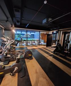 a gym with several treadmills and a fish tank at Vistula loft apartment , free parking! in Kraków