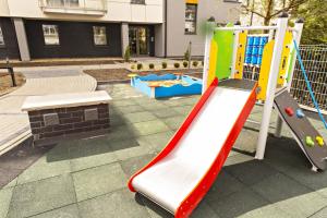 a playground with a slide and a play equipment at Apartament MAJA Giżycko Żeglarska in Giżycko
