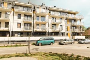 a building with cars parked in front of it at Apartament MAJA Giżycko Żeglarska in Giżycko +12 photos
