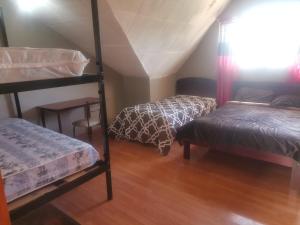 a room with two bunk beds and a table at La Muralla in Cuenca