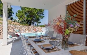 een eetkamer met een tafel met een vaas met bloemen bij Villa Miramarina in Tribunj +40 foto's
