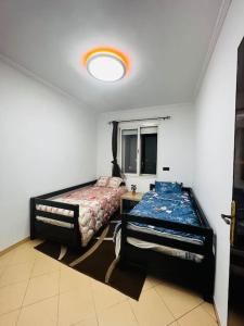 a bedroom with two beds and a window at Appart à 2 min de Casanearshore in Casablanca