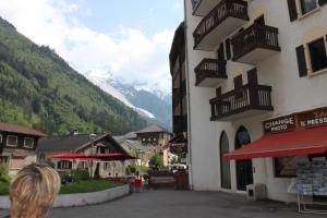 a woman is looking out at the mountains from a building at Apartment Batiment F in Chamonix