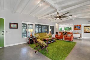 a living room with a ceiling fan and a green rug at Ultra-Luxury- Resort Style Private Compound-Close to Everything- 3BD/2.5BA in Palm Springs