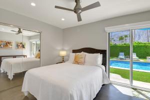 a bedroom with two beds and a pool at Ultra-Luxury- Resort Style Private Compound-Close to Everything- 3BD/2.5BA in Palm Springs +27 photos