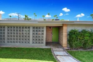 a house with a green door in a yard at Ultra-Luxury- Resort Style Private Compound-Close to Everything- 3BD/2.5BA in Palm Springs