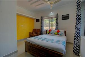 a bedroom with a large bed in a room at Coorg Vacation Stay(KKR) in Madikeri