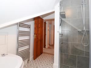 a bathroom with a shower and a toilet and a sink at Cherry Tree Cottage in Windermere +25 photos