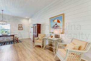 a living room with a table and chairs and a piano at 2505B W, 5th St condo in Fernandina Beach