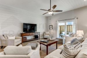 a living room with white furniture and a flat screen tv at 2505B W, 5th St condo in Fernandina Beach
