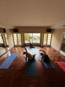 a group of people doing yoga in a room at Rodex Hostel Tucuman in San Miguel de Tucumán